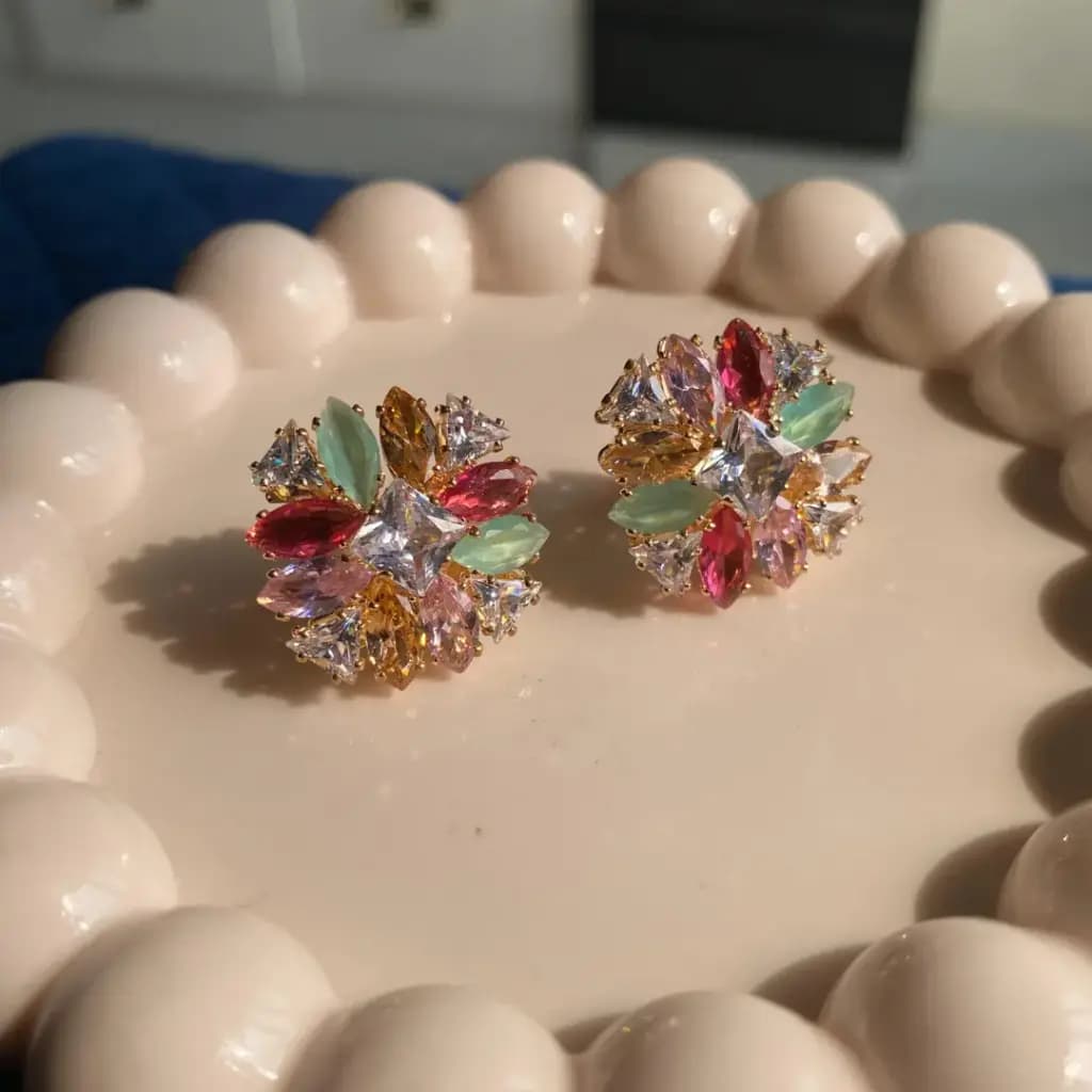 Cluster of pale multicolour cubic zirconia in marquise and trillion cuts on a gold-plated stud